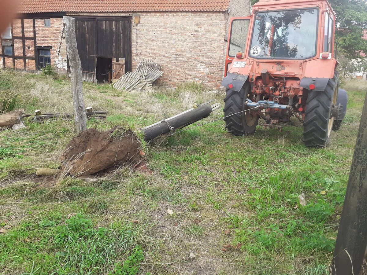 A neighbor helping with fence posts
